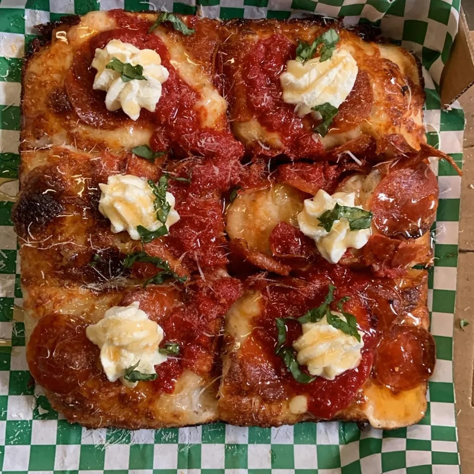 L.A. Waterfront Pizza's square pepperoni pizza with dollops of ricotta, basil, and honey drizzle.